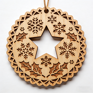 Wooden Christmas ornament with laser engraving and cutting.