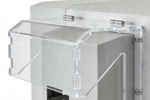 High-precision laser-cut polycarbonate safety enclosure mounted on industrial machinery, featuring clean edges and interlocking joints.