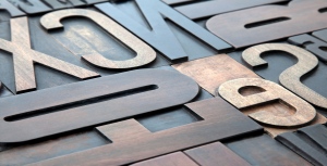Laser cutting and engraving wooden commercial signage.