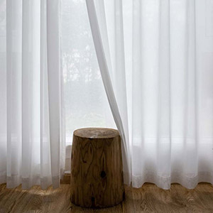 Laser-cut white chiffon sheer curtains create artistic patterns that highlight a sense of high-end sophistication.